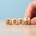 Concept of changing the year from 2021 to 2022 on wooden cubes by hand.