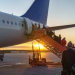 People boarding plane, travelers