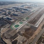 Los Angeles, California, USA - August 16, 2016:  Afternoon aerial view of airplanes lining up on the runway at busy LAX airport in Southern California.