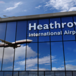 Airplane landing at London Heathrow mirrored in terminal