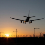 Landing passenger plane during sunset.