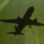Shadow of the plane on the agricultural field. Concept of decarb