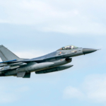 Military F16 fighter jet close up flying through the air. Royal Netherlands Air Force F16 fighter jet aircraft taking off. Jet F-16 fly in the sky.