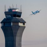 Airport control tower during takeoff airplane