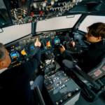 An experienced pilot instructs a young student before a training flight in the cockpit of an aero simulator