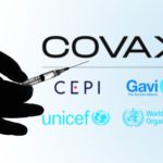 May 5, 2021, Brazil. In this photo illustration the medical syringe is seen with COVAX Facility logo displayed on a screen in the background.