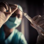 Doctor holding a coronavirus COVID-19 test tube