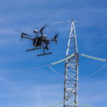 Drone-being-flown-to-inspect-power-lines-scaled