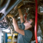 A proud and confident female aerospace engineer works on an airc