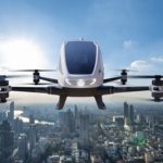 Autonomous driverless aerial vehicle flying on city background,