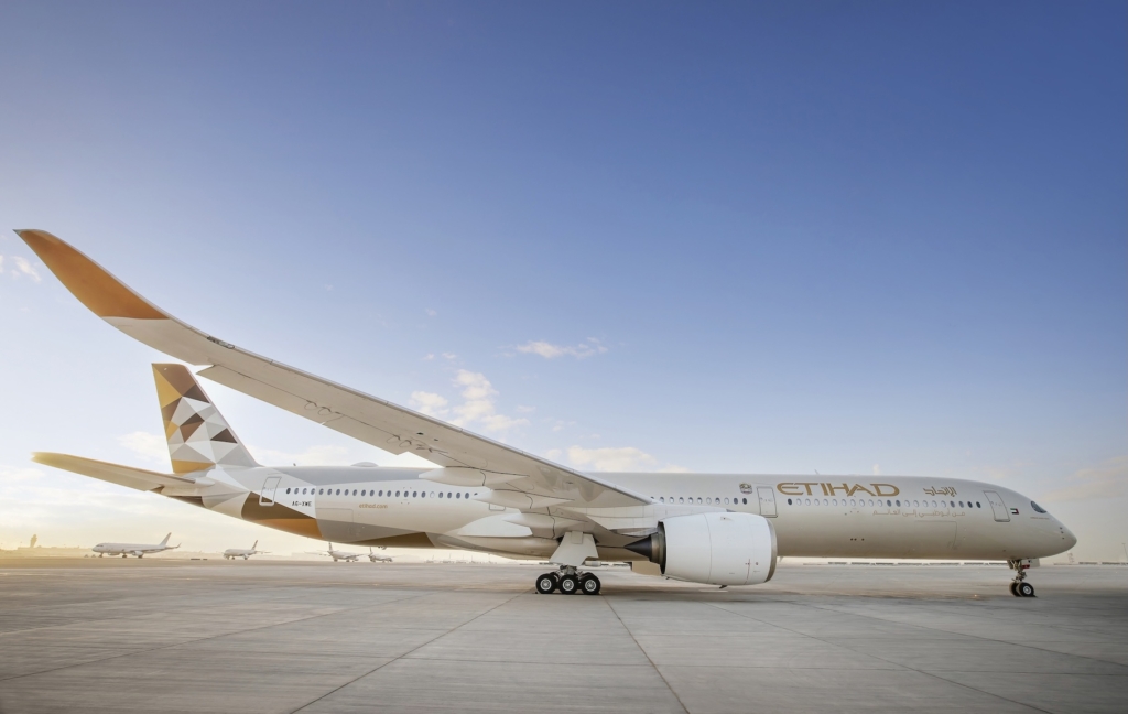An Etihad A350 with aircraft in the background in Abu Dhabi