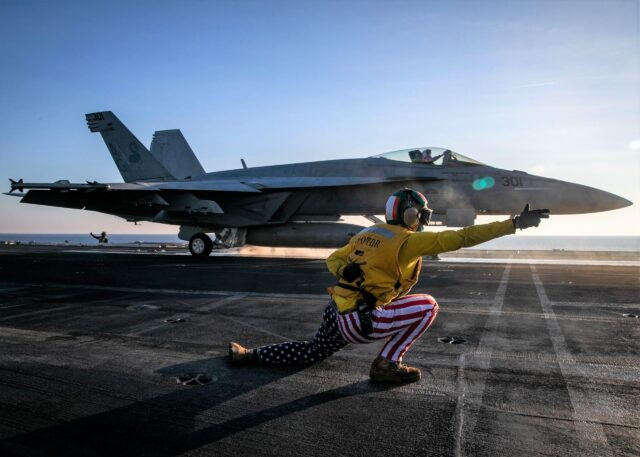 US Navy F/a-18 launching from a carrier