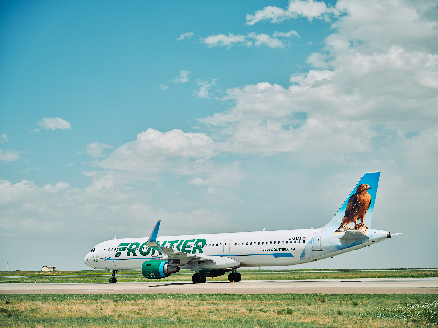 Frontier Airlines planes taxi at Denver International Airport in Denver, Colorado, Tuesday, June 14, 2022.