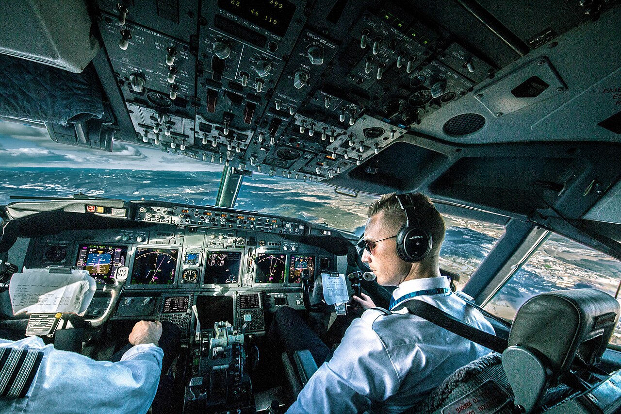 Pilots in Boeing 737 cockpit during flight.