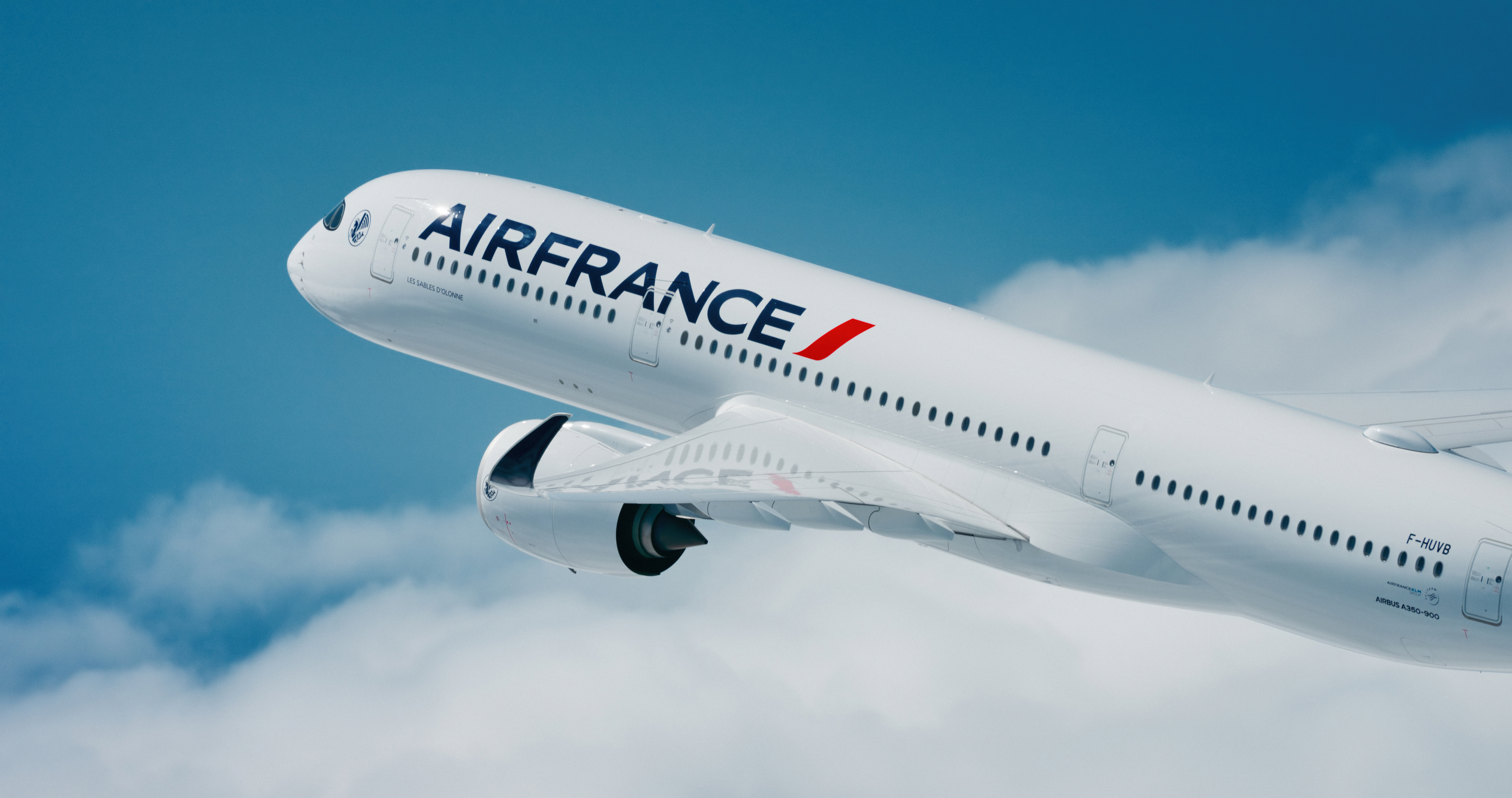 Air France Airbus A350 flying in the blue sky with clouds.