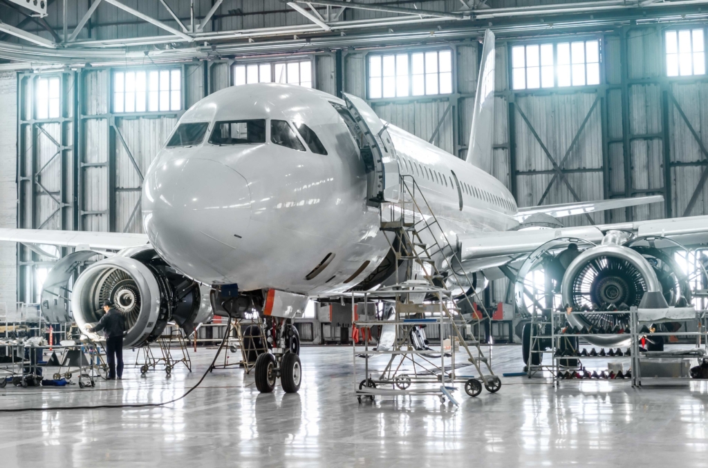 Passenger aircraft on maintenance of engine and fuselage repair in airport hangar MRO