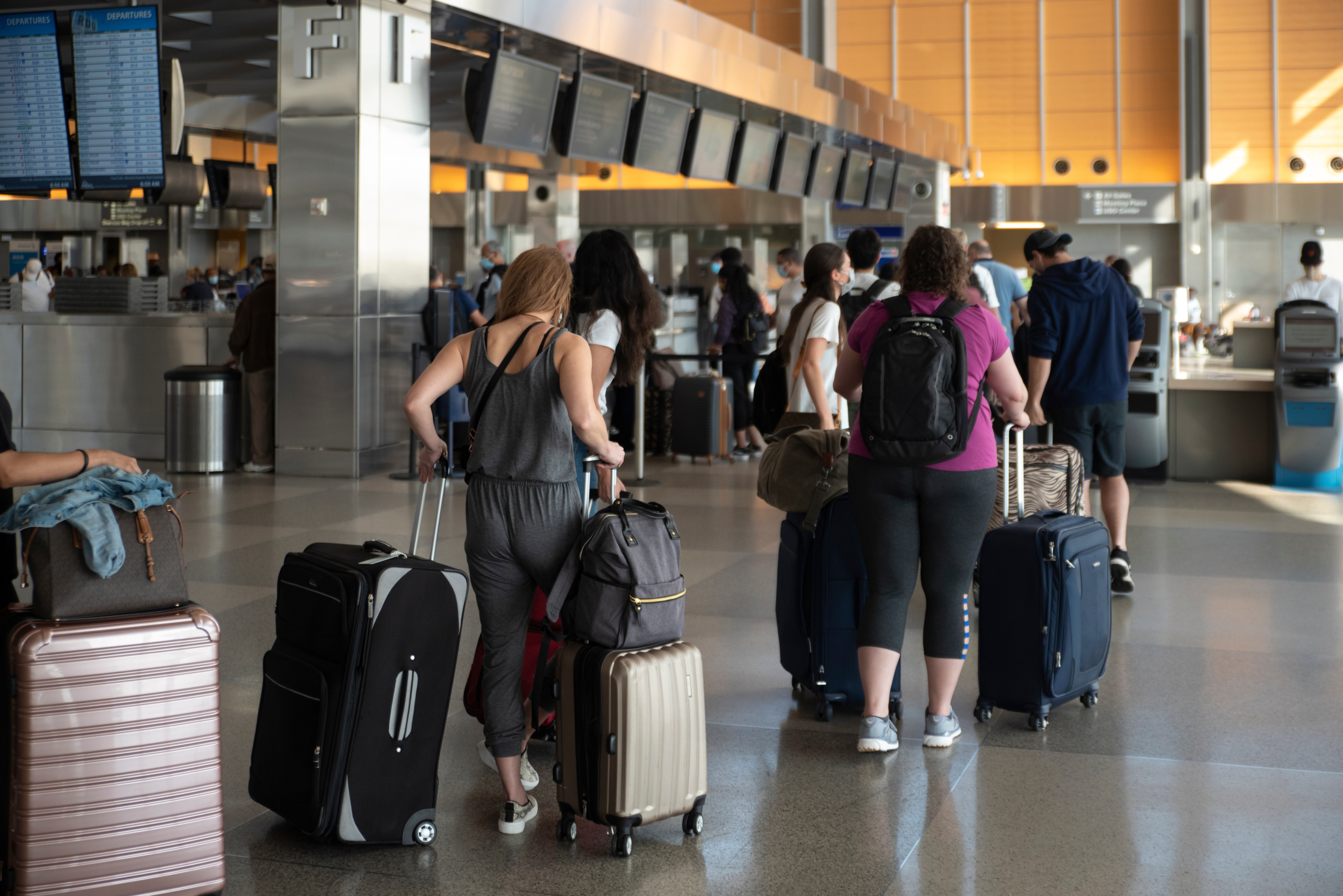 Airline passengers stand in long queues