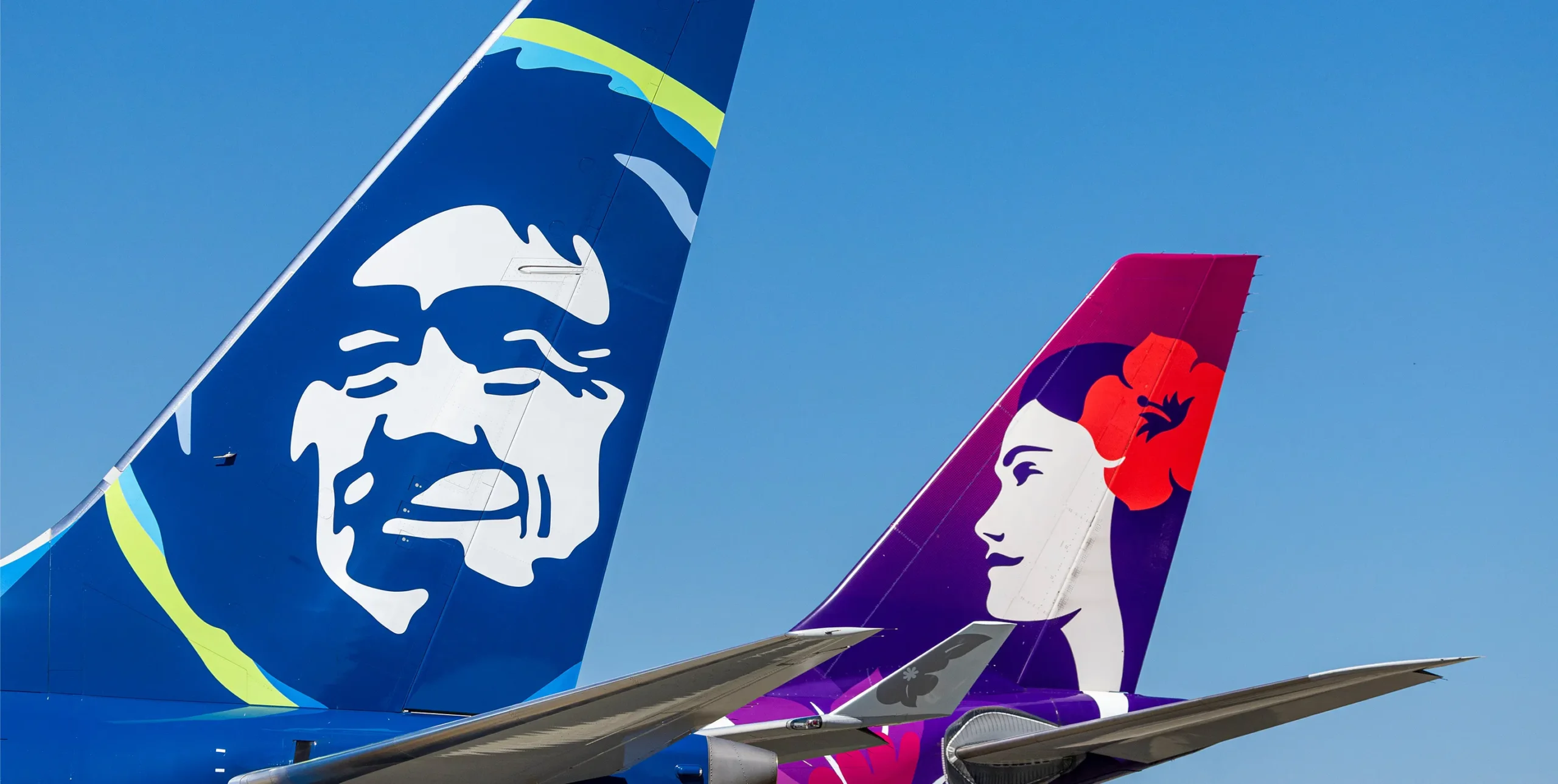 Alaska Airlines and Hawaiian Airlines icons on aircraft tails