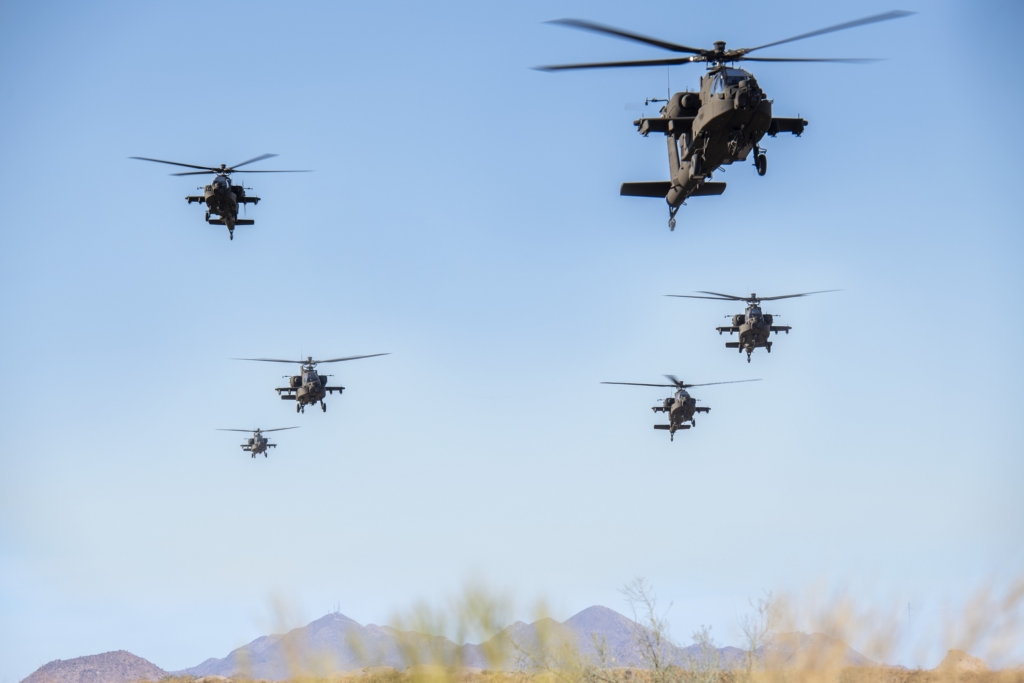 AH-64 Apaches perform a flyover at the Boeing Mesa site in Arizona
