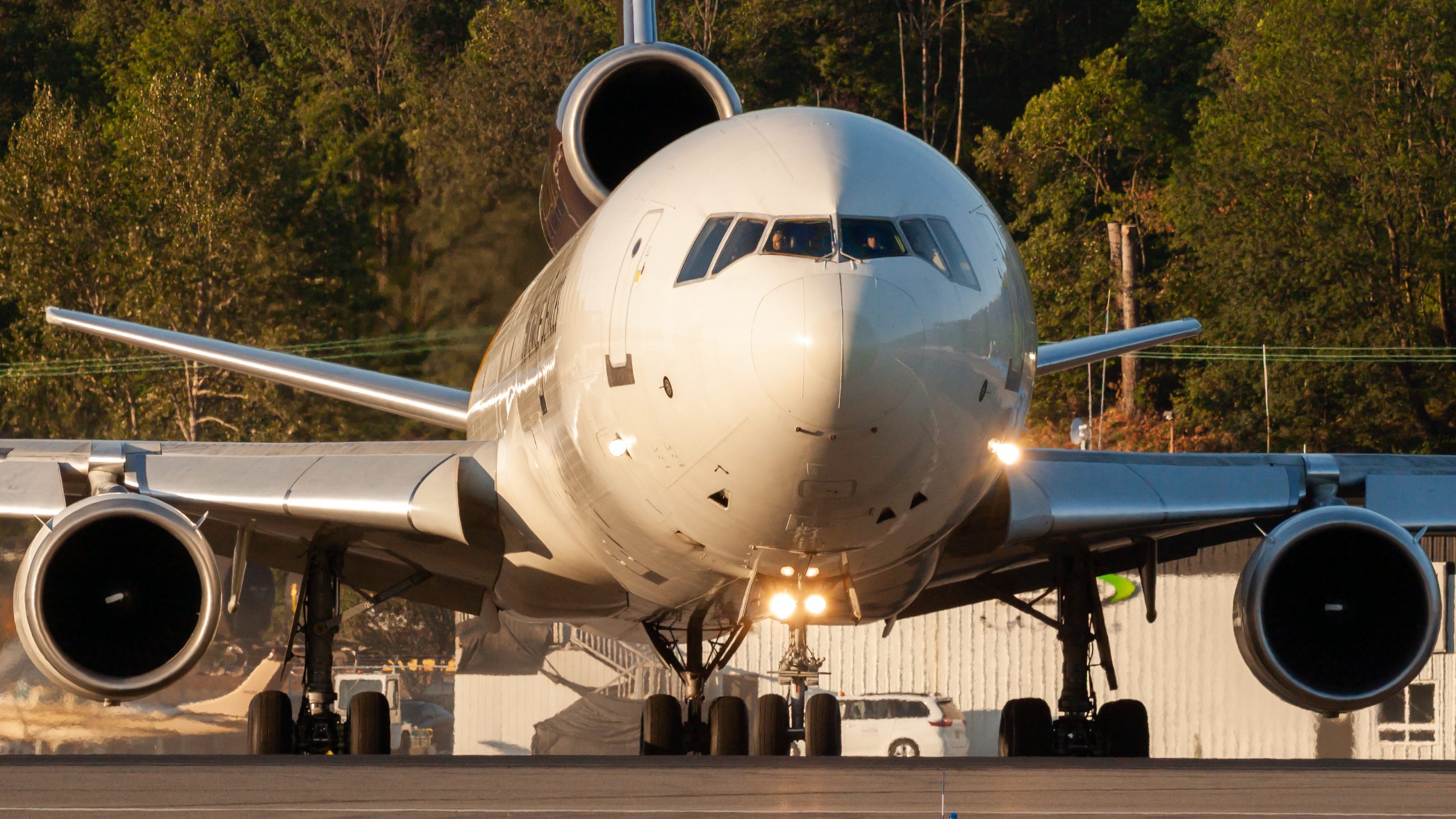 A UPS MD-11 front shot taxiing at Boeing Field in the evening.