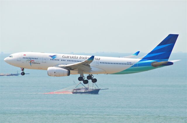 Garuda Indonesia aircraft flying over sea