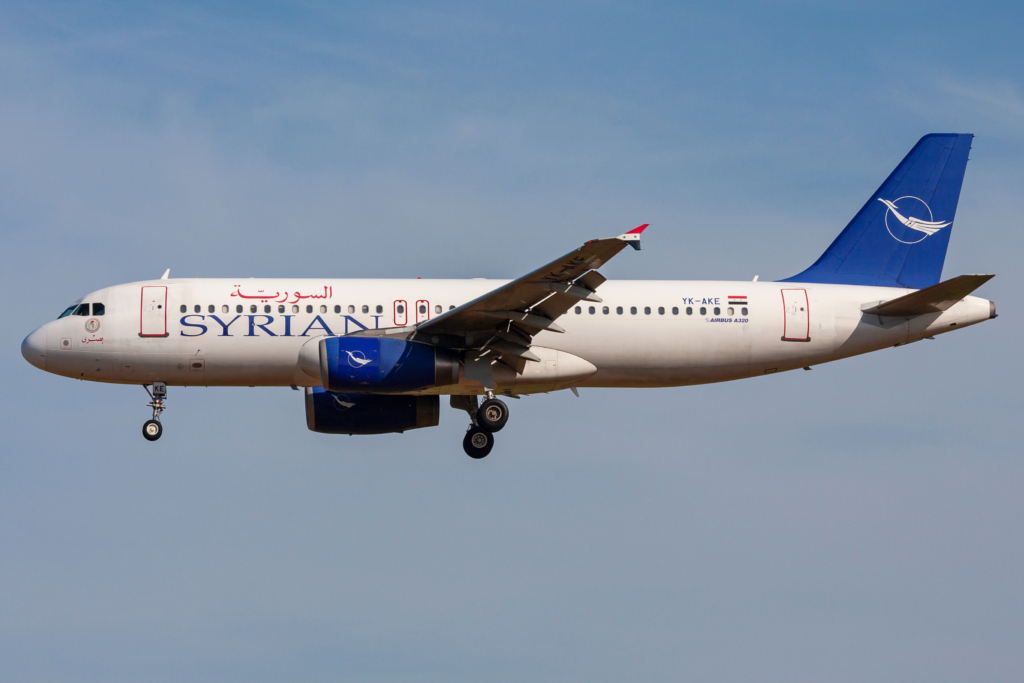 Syrian Air Airbus A320 aircraft landing in front of a blue sky in Belgium