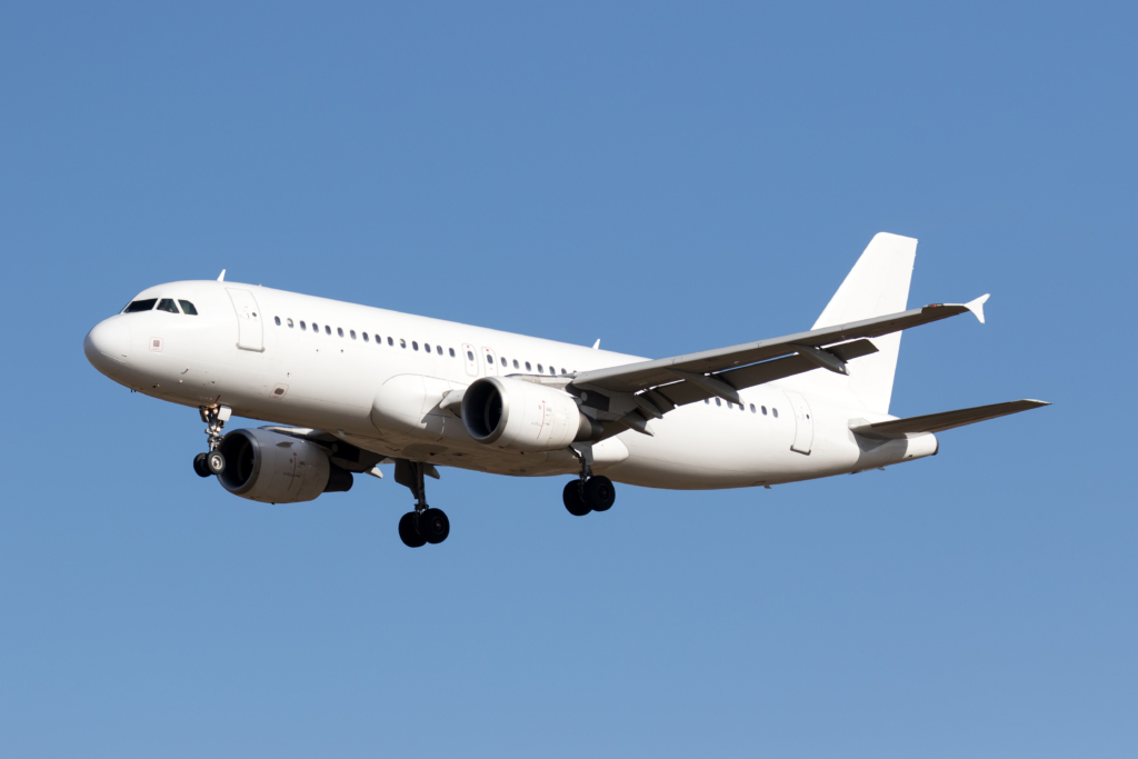 A white Airbus A320 aircraft on final approach to land.