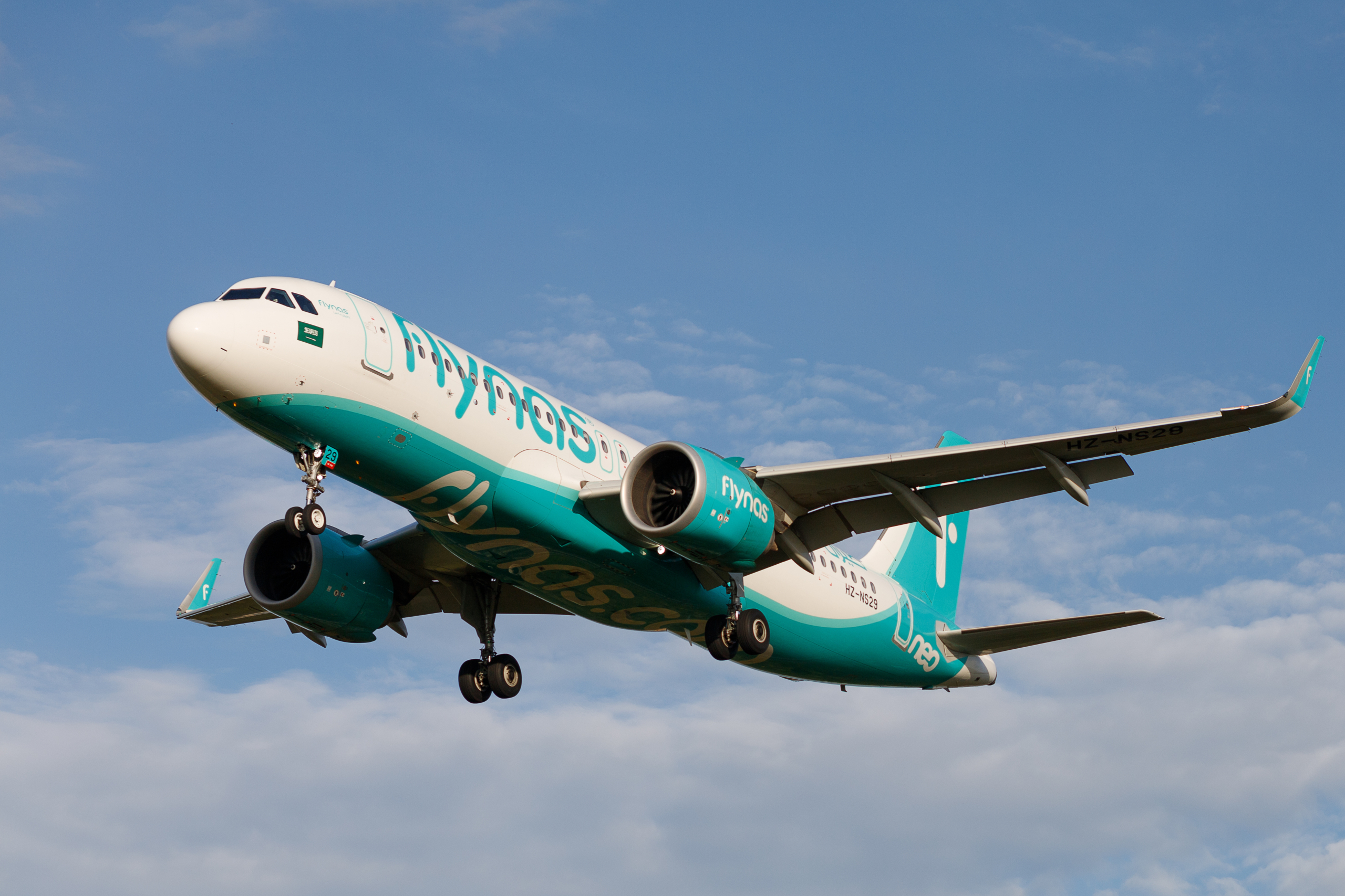 LVIV, UKRAINE - September 28, 2021: flynas airline Passenger plane in flight. The plane flies in the sky.