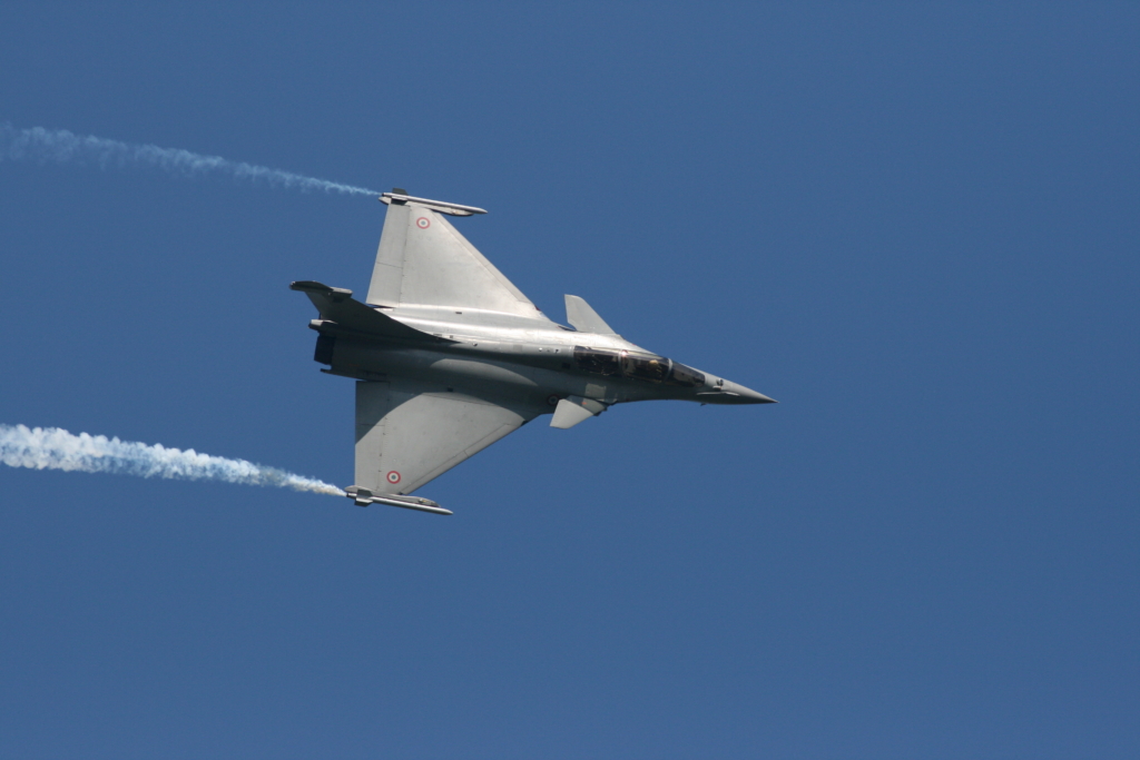 Rafale flying in the sky with smoke coming out