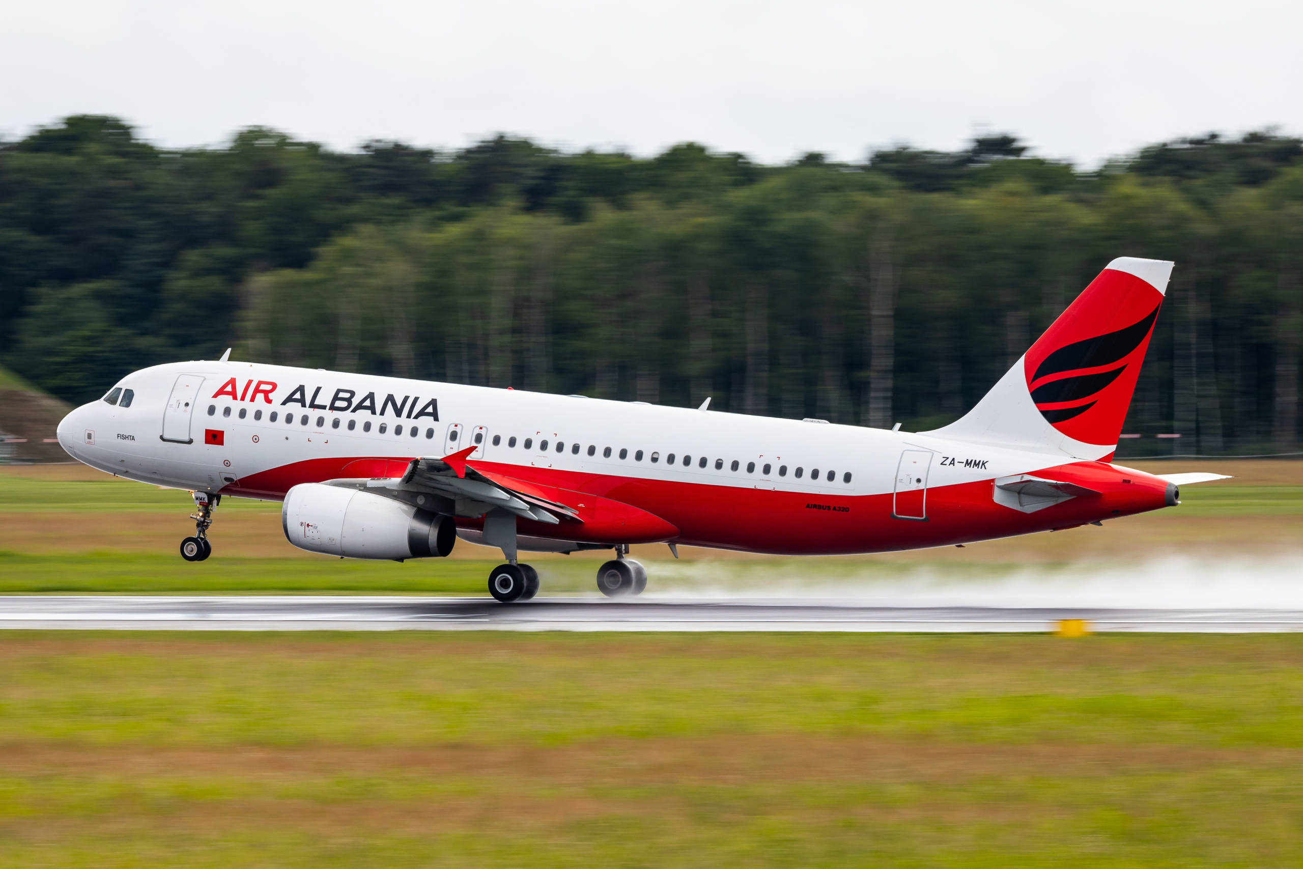 Graz, Austria - May 31, 2024: Air Albania departing on a wet runway in Graz with an Airbus A320 aircraft to Tirana