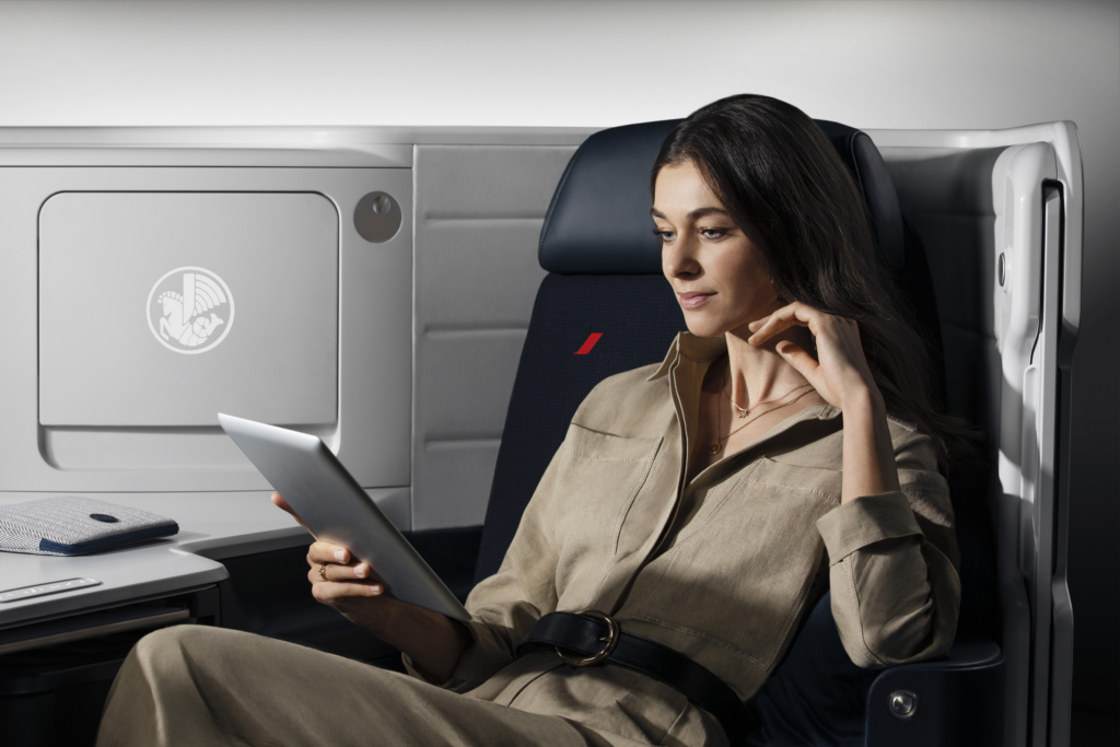 Air france Boeing 777 business class with a woman using her device.