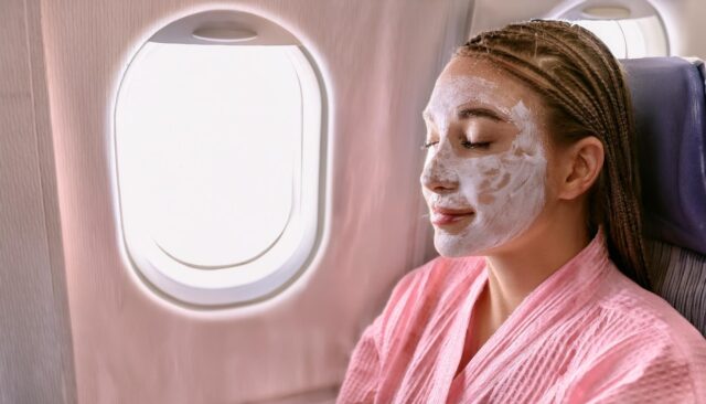 Passenger wearing beauty treatment face mask on plane.