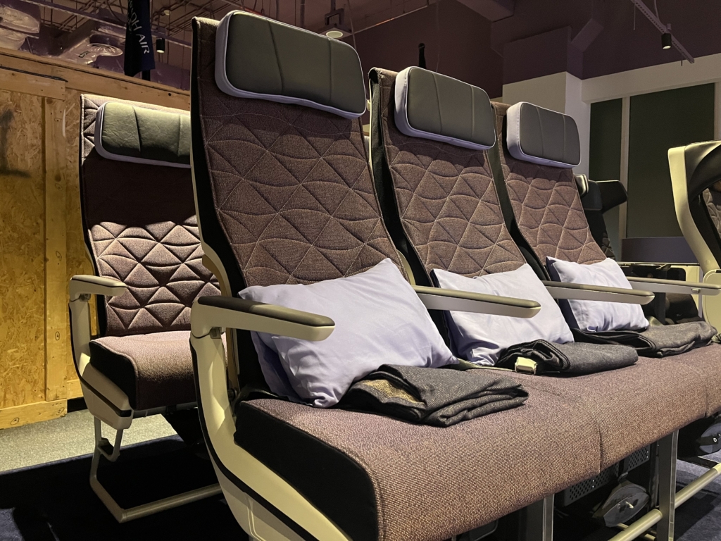 Riyadh Air economy class seats with cushions.