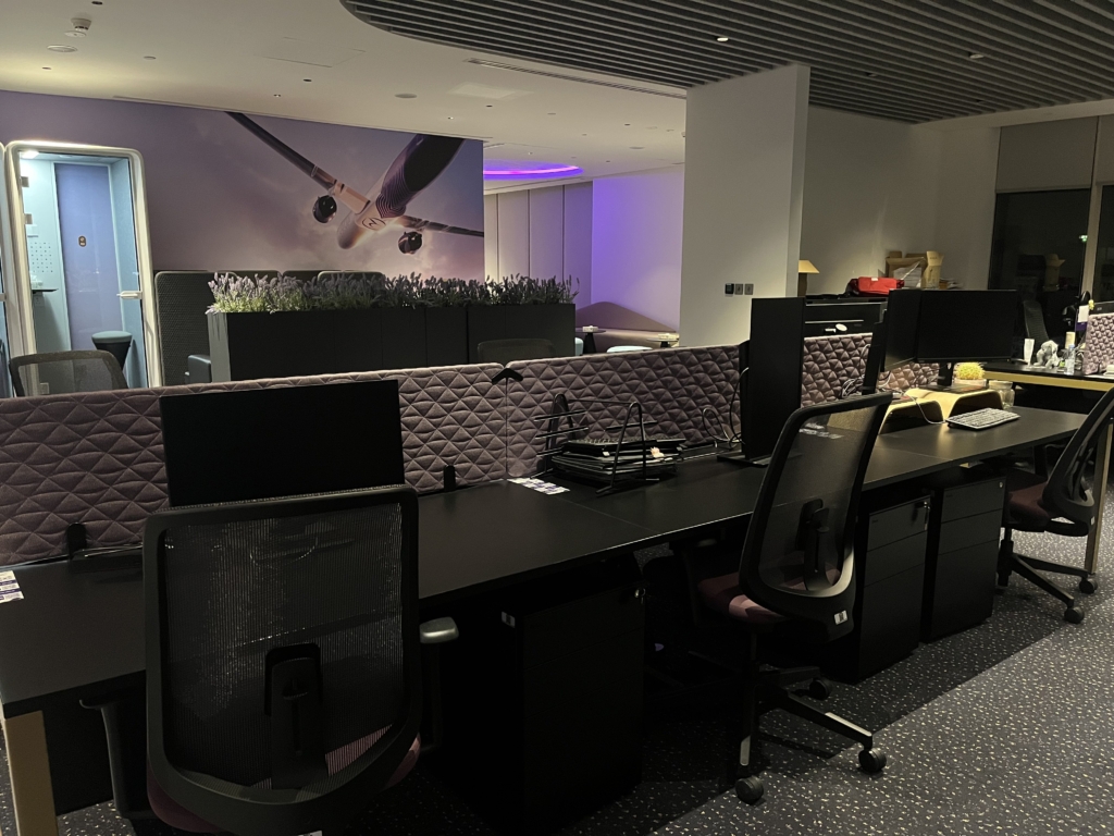 Riyadh Air's office with purple tones. Desks and chairs shown as well.