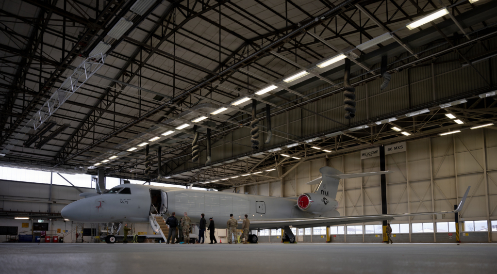 A USAF-operated EA-37B Compass Call (serial 17-5579/'DM') - operated by the 55th ECG - rests in a hangar shortly after arriving at Ramstein AB, Germany, on 26 January 2026. Image: USAF/Senior Airman Edgar Grimaldo