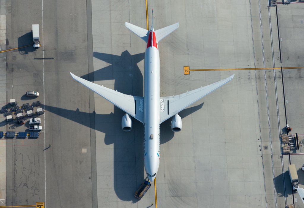 American Airlines Boeing 777 being towed at Los Angeles International Airport. Aerial view of 777-300 aircraft registered as N726AN showing black stripes on wings