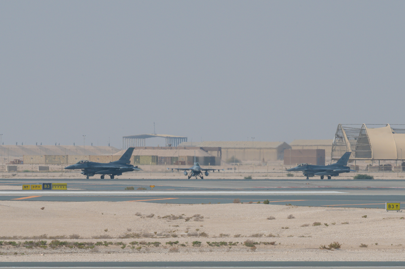 Three Air Force F-16 Fighting Falcon aircraft taxi in Qatar