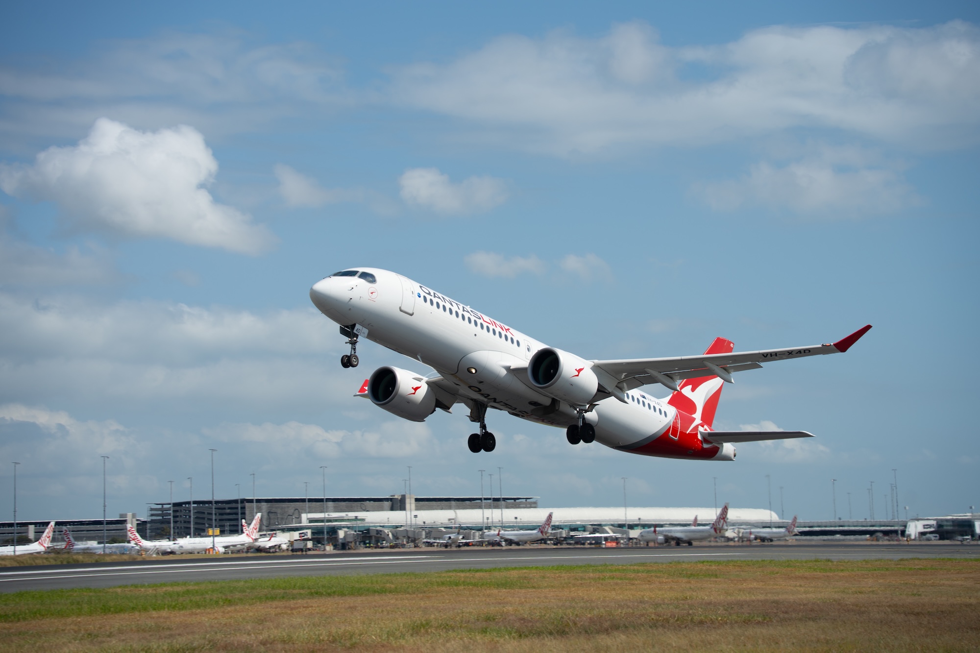 QantasLink Airbus A220 takes off from Brisbane Airport on first international flight.