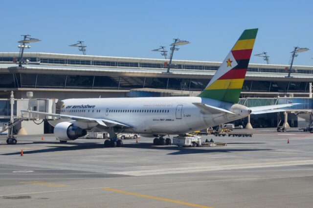 Air Zimbabwe Boeing 767 parked at the gate.