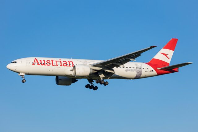 Vienna, Austria - 30 April, 2023: Long haul aircraft Boeing 777 of Austrian Airlines landing in front of blue sky