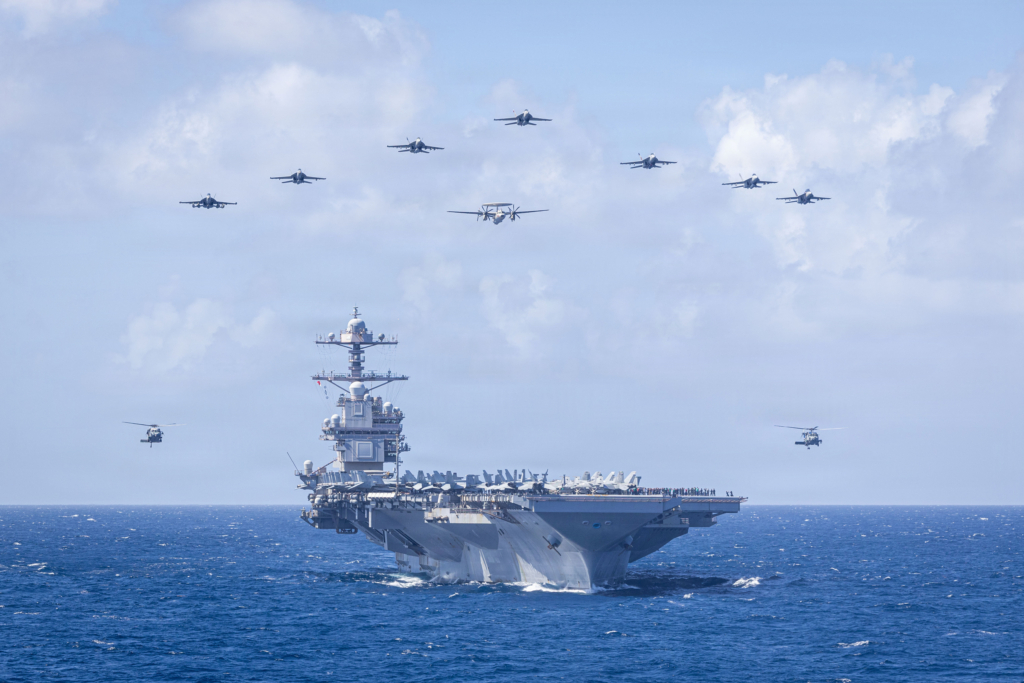 Aircraft assigned to CVW-8 conduct a flypast over USS Gerald R Ford during a change of command ceremony that was held as the vessel sailed through the Caribbean Sea on 19 January 2026. Image: US Navy