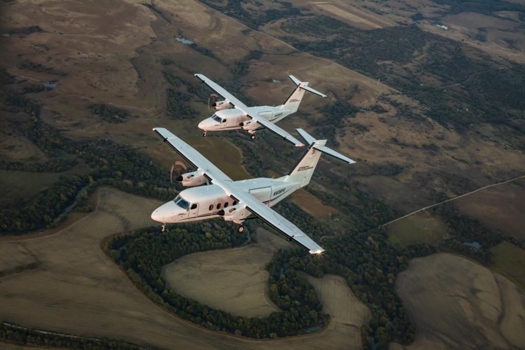 A pair of cargo-configured Cessna 408 SkyCouriers fly together in formation. The aircraft are suited for rugged operations in austere environments. Image: Textron Aviation