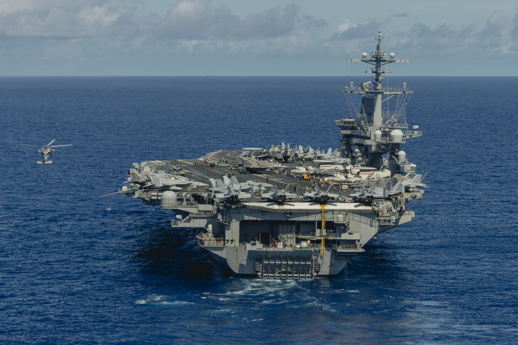 An MH-60S Seahawk hovers next to the Nimitz-class 'flattop', USS George Washington (CVN-73), during a SAR drill in the Philippine Sea on 9 August 2025. Image: US Navy/Mass Communication Specialist 3rd Class Geoffrey L Ottinger