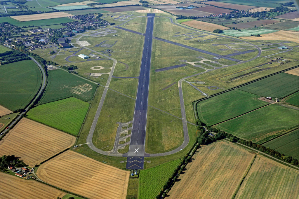 This bird's eye image offers a perfect view of RAF Scampton's length main runway, which is 2,470m (8,103ft) long and 60m (196ft) wide. The base's secondary runway can easily be seen crossing the main runway, but is not operational due to concerns with its surface. Image via Newmark Group