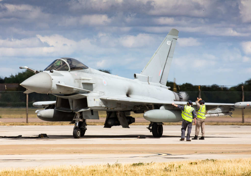 A Typhoon FGR4 from the RAF's No 3(F) Squadron is directed to its parking spot on the flightline at RAF Coningsby after returning from a NATO enhanced Air Policing (eAP) deployment to Romania as part of Operation Biloxi on 3 August 2022. Image: MOD Crown Copyright/Cpl Sally Raimondo