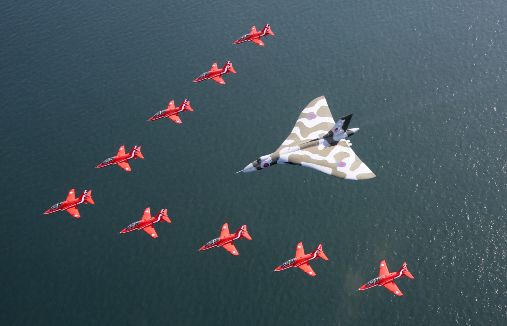 Over the years, RAF Scampton has played host to many of the UK's mighty aviation icons - including the Avro Vulcan and RAFAT Red Arrows - both of which are pictured flying together for the final time on 19 September 2015. Image: MOD Crown Copyright/Cpl Steve Buckley