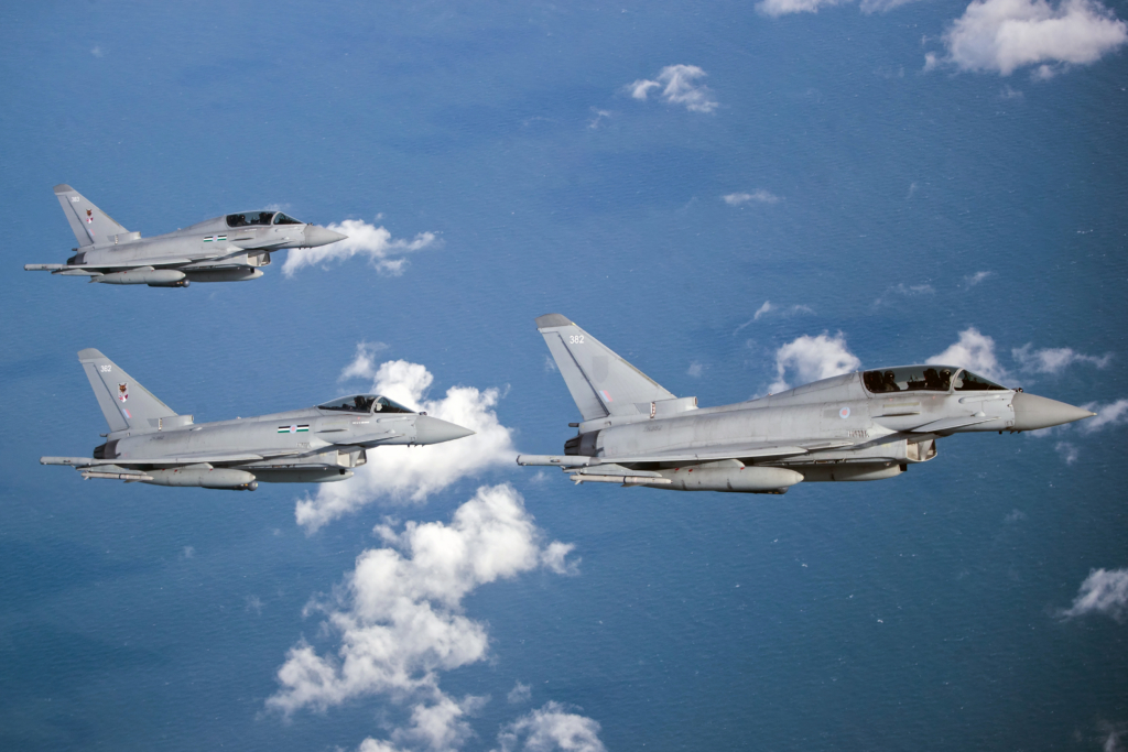 Three Eurofighters - comprising one single-seat Typhoon FGR4 and two dual-seat Typhoon T3s - from the RAF's No 12(B) Squadron fly together in formation over the North Sea on 14 October 2020. This joint British-Qatari unit is responsible for training Qatari air/ground crews to operate the fighter. Image: MOD Crown Copyright/Cpl Ed Wright