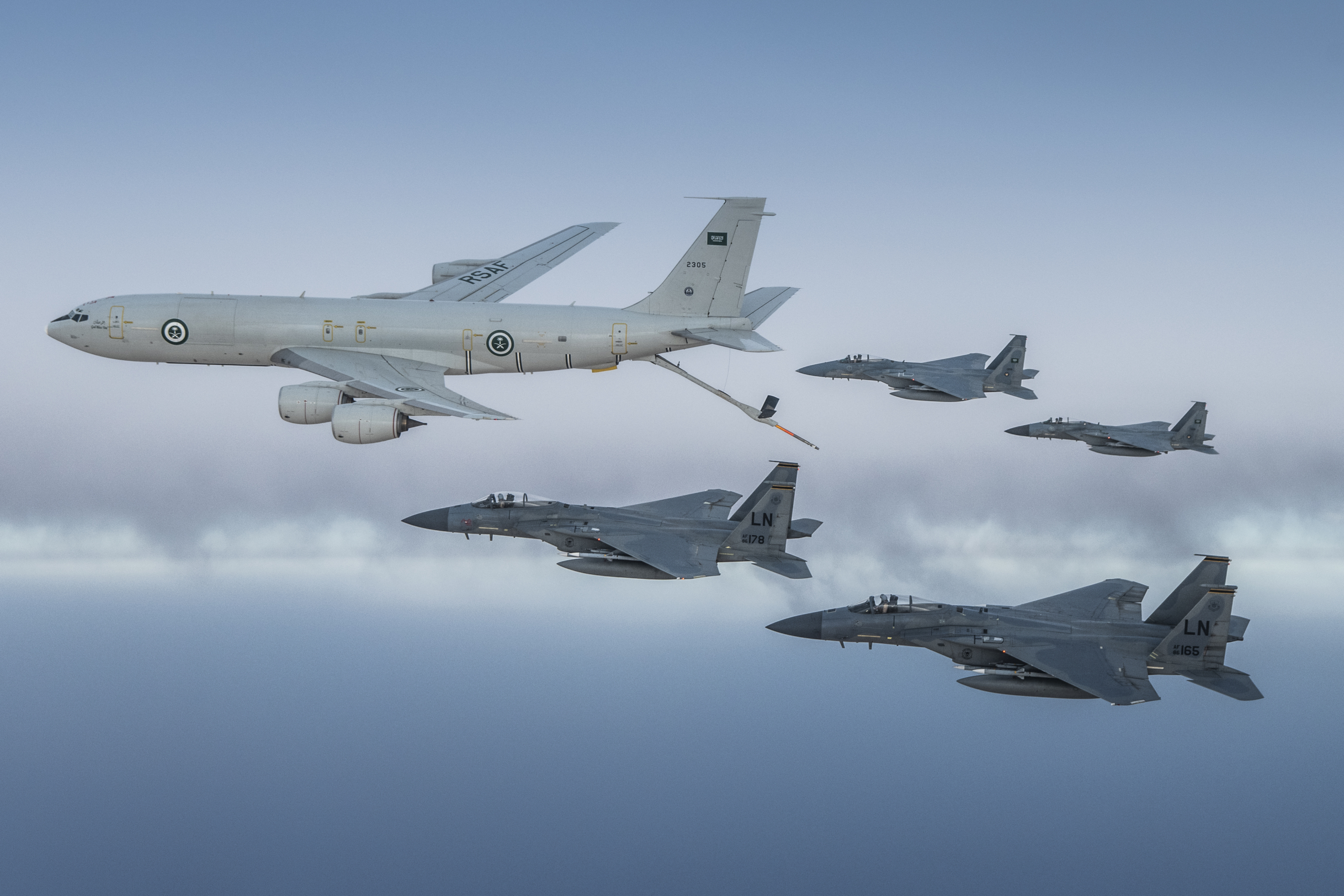 A pair of RSAF-operated F-15Cs and two USAF F-15Cs fly in formation with a Saudi KE-3A tanker aircraft during an air-to-air refuelling mission over the Middle East on 2 June 2019. Image: RSAF