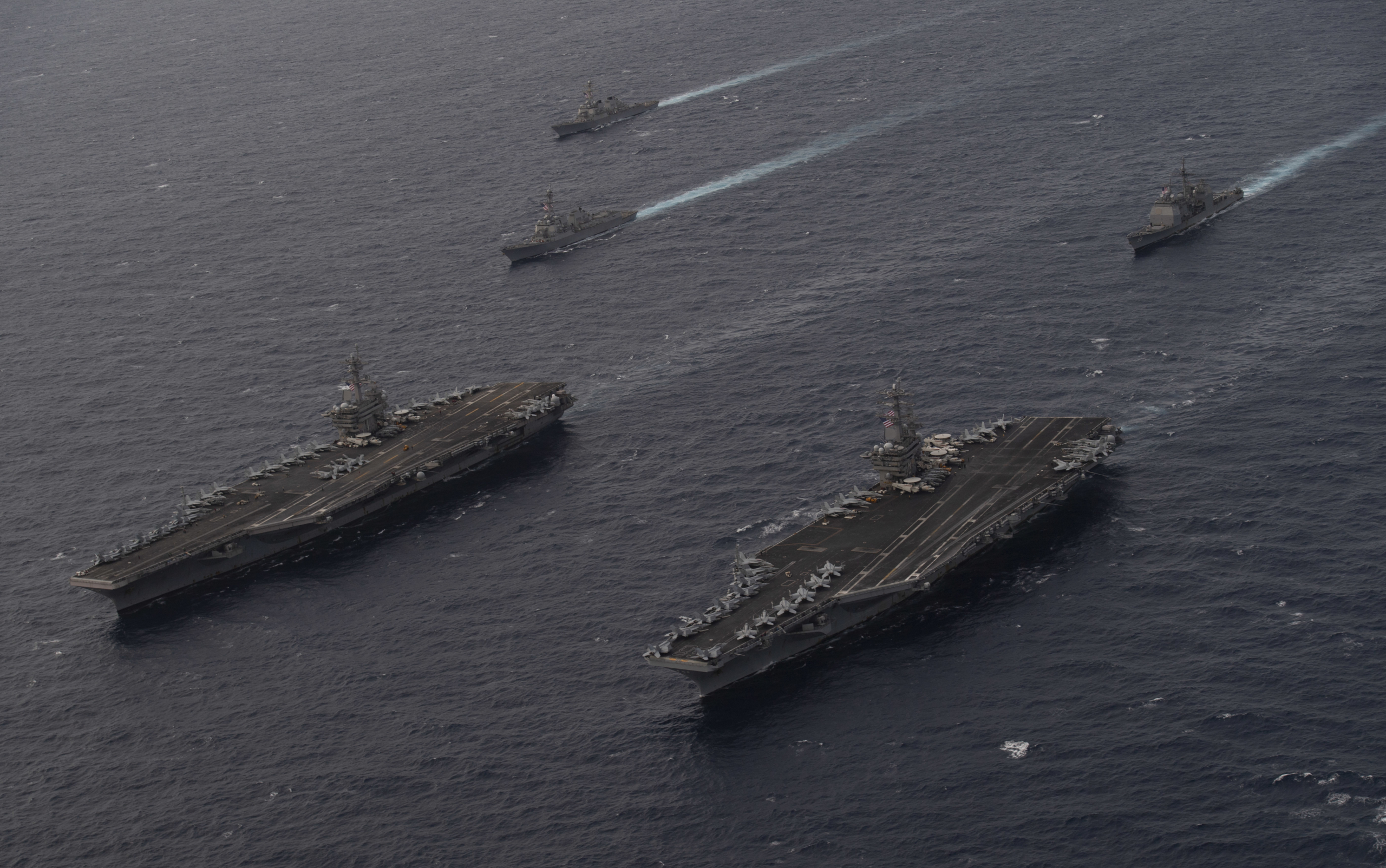 Two of the US Navy's Nimitz-class warships - comprising the USS Theodore Roosevelt (CVN-71) and USS Nimitz (CVN-68) - sail together during a drill in the South China Sea on 9 February 2021. Image: US Navy/Mass Communication Specialist 3rd Class Elliot Schaudt