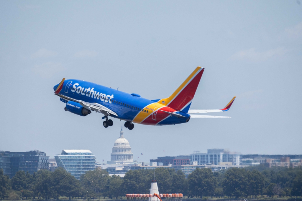 Southwest Airlines Boeing 737 flying over skyline with US Capitol visible during daytime. Washington DC